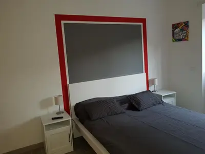 a bed with a large headboard in a bedroom at In Rome Trastevere Rooms in Rome