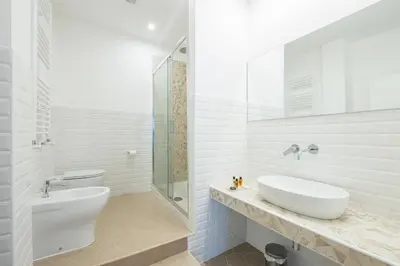 a white bathroom with a sink and a toilet at Magenta Luxury Argentina in Rome
