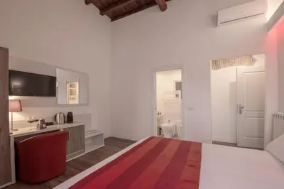 a hotel room with a bed and a bathroom at Magenta Luxury Argentina in Rome