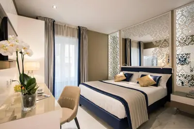 a bedroom with a bed and a desk and a mirror at Residenza Venti Settembre in Rome