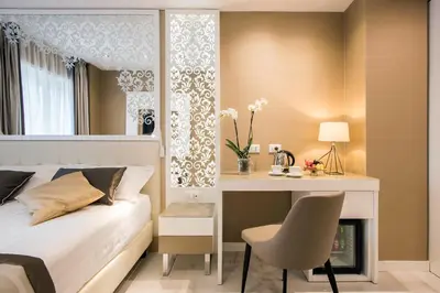 a bedroom with a bed and a desk and a mirror at Residenza Venti Settembre in Rome