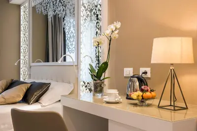 a living room with a bed and a table with a lamp at Residenza Venti Settembre in Rome