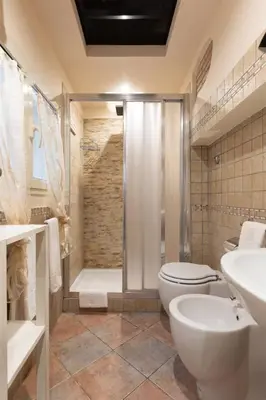 a bathroom with a shower and a toilet and a sink at Rione Di Roma Center Apartment in Rome