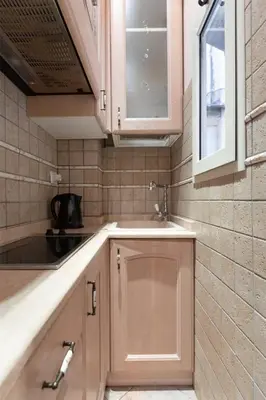 a small kitchen with a sink and a window at Rione Di Roma Center Apartment in Rome
