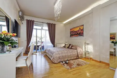 a bedroom with a bed and a table and a desk at Luxury Rome Guest House in Rome