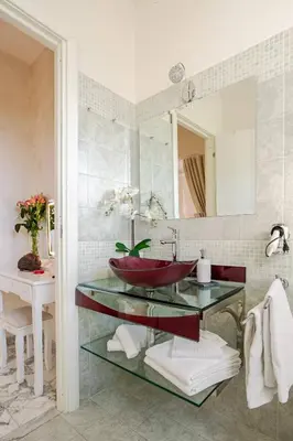 a bathroom with a red sink and a mirror at Luxury Rome Guest House in Rome