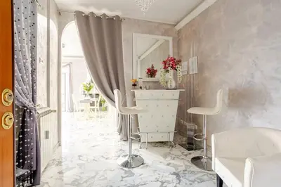 a bathroom with a sink and two stools at Luxury Rome Guest House in Rome