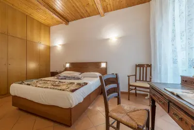 a bedroom with a bed and a desk and a chair at GuestHost - Elegant Apartment in Rome in Rome