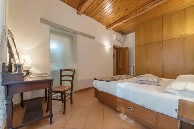 a bedroom with a desk and a bed and a table at GuestHost - Elegant Apartment in Rome in Rome