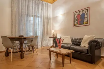 a living room with a couch and a table at GuestHost - Elegant Apartment in Rome in Rome