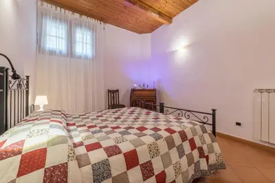 a bedroom with a bed with a quilt on it at GuestHost - Elegant Apartment in Rome in Rome