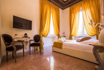 a bedroom with a bed and a desk with chairs at Trastevere Royal Suite Trilussa in Rome