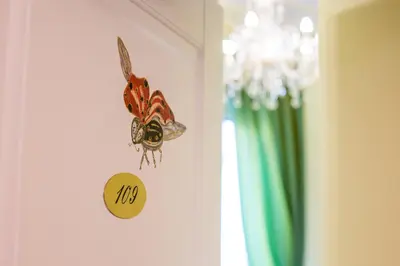 a clock on a door with a butterfly on it at Trastevere Royal Suite Trilussa in Rome