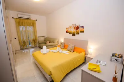 a bedroom with a large yellow bed in a room at Hello Rose - Appartamento intero in Rome
