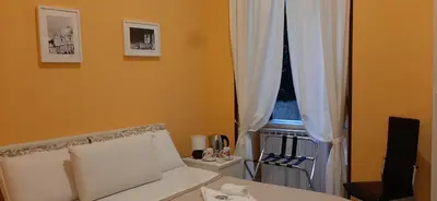 a room with a bed and a window with curtains at My Trevi Rooms 88 in Rome
