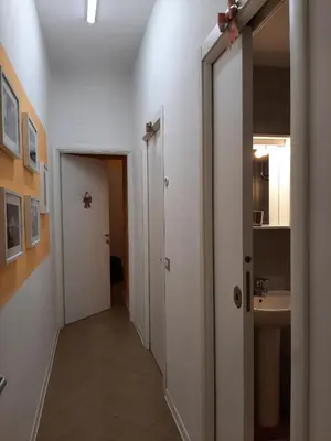 a hallway with a bathroom and a sink at My Trevi Rooms 88 in Rome