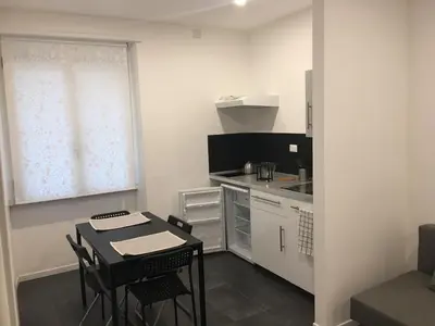 a small kitchen with a small table and a table and chairs at Ale 160 in Rome