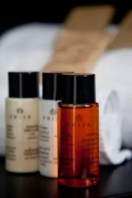 a group of four bottles of moisturizers on a table at Residenza Pantaleo in Rome