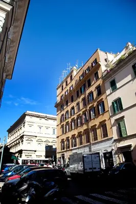 a group of buildings on a city street with cars at Residenza Pantaleo in Rome
