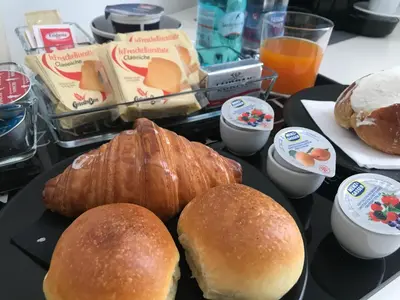 a tray of food with bread and pastries on it at Residenza Pantaleo in Rome