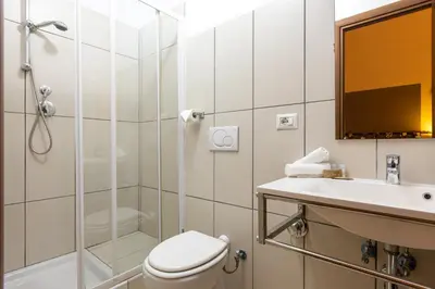 a bathroom with a shower and a toilet and a sink at San Lorenzo Rooms in Rome