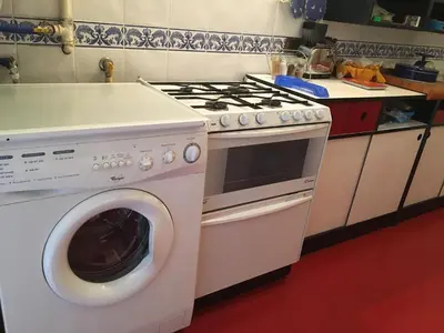 a kitchen with a stove and a washing machine at Elle house Roma in Rome