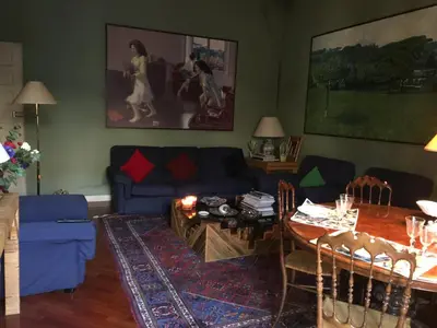 a living room with a blue couch and a table at Elle house Roma in Rome