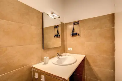 a bathroom with a sink and a mirror at Guest House o Affittacamere La Civetta di Trastevere B in Rome
