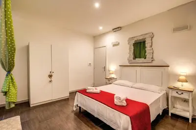 a bedroom with a large bed with a red blanket at Guest House o Affittacamere La Civetta di Trastevere B in Rome