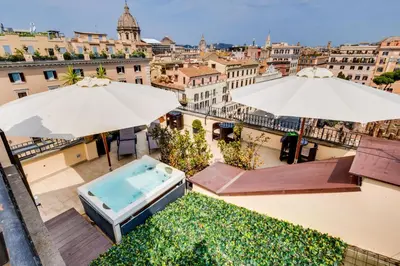 a view of the city from a balcony with umbrellas at V Collection Relais Badoer in Rome