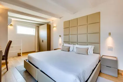a bedroom with a large white bed and a desk at V Collection Relais Badoer in Rome