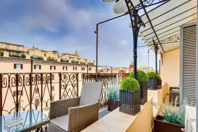 a balcony with chairs and a view of a building at V Collection Relais Badoer in Rome