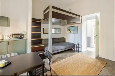 a living room with a loft bed and a table at Rome Apartment San Pietro - Monte del Gallo in Rome