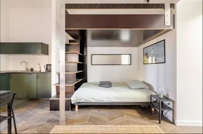 a bedroom with a loft bed and a kitchen at Rome Apartment San Pietro - Monte del Gallo in Rome