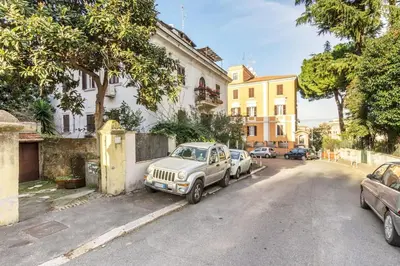 a white car parked on the side of a street at Rome Apartment San Pietro - Monte del Gallo in Rome