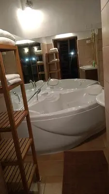 a large white bath tub in a bathroom at Jacuzzi Quo Vadis in Rome