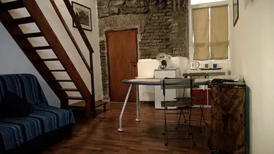 a living room with a table and a staircase at Jacuzzi Quo Vadis in Rome