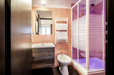 a bathroom with a toilet and a shower and a sink at Old Kitchen Vatican Suites in Rome