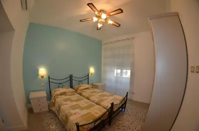 a bedroom with two beds and a ceiling fan at Bed&bookofrome in Rome