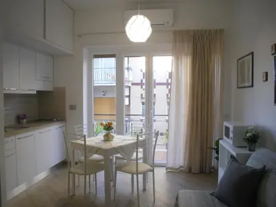 a kitchen and dining room with a table and chairs at Lovely Little Apartment in Via Aurelia in Rome