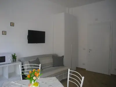 a living room with a couch and a table with chairs at Lovely Little Apartment in Via Aurelia in Rome