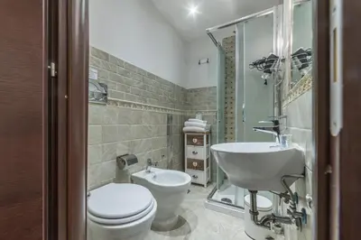 a bathroom with a toilet and a sink at Residenza Sistina in Rome