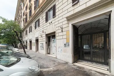 a building on a street with cars parked next to it at Residenza Sistina in Rome