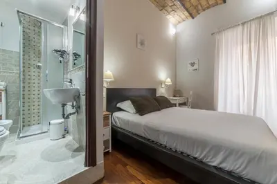 a bedroom with a bed and a bathroom with a shower at Residenza Sistina in Rome