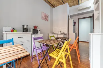 a kitchen with colorful chairs and tables in a room at Residenza Sistina in Rome
