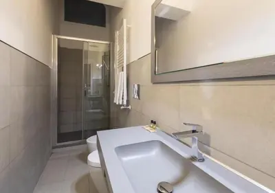 a bathroom with a sink and a toilet and a mirror at Residenza Palline by Hili in Rome