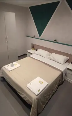 a bedroom with a large bed with two towels on it at Eden guest house in Rome