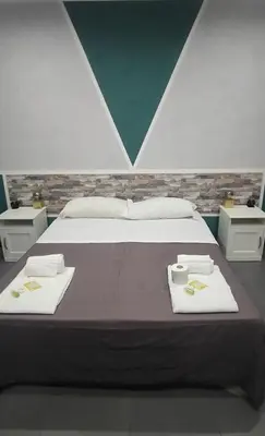 a bedroom with a bed with two towels on it at Eden guest house in Rome