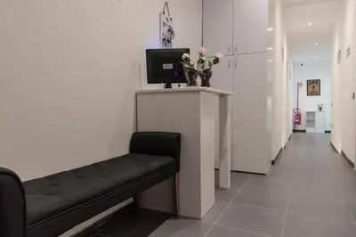 a waiting room with a bench and a tv at Eden guest house in Rome
