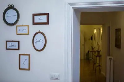 a hallway with framed pictures on a wall at Your Secret Pantheon in Rome